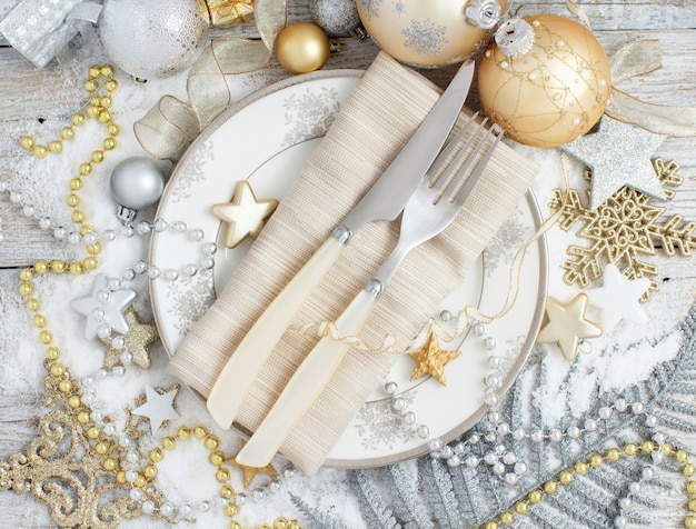 Silver and golden Christmas Table Setting with Christmas decorations