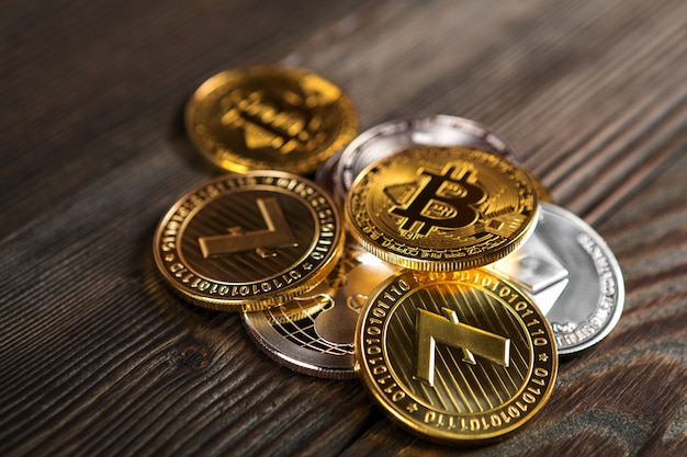 Silver and golden coins with bitcoin, ripple and ethereum symbol