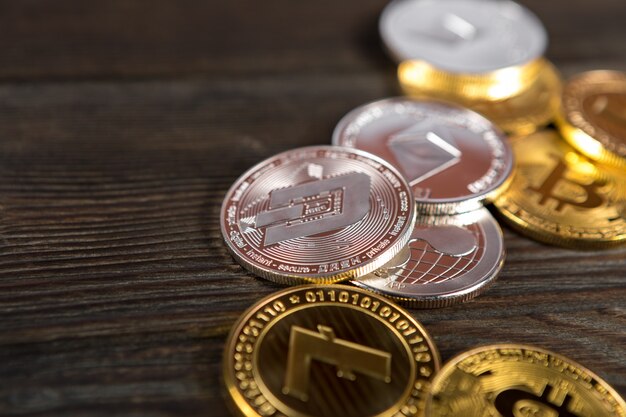 Silver and golden coins with bitcoin, ripple and ethereum symbol