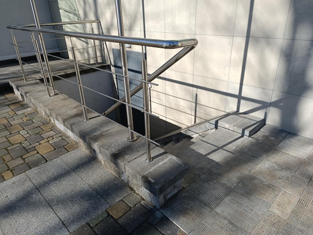 A silver handrail on the steps