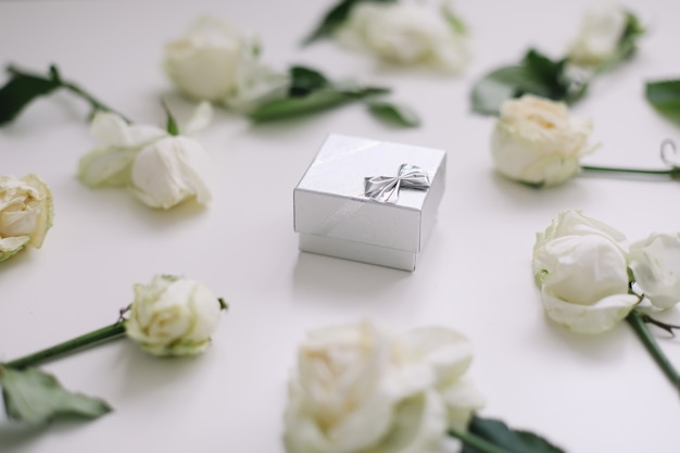 Silver jewelry box and white roses