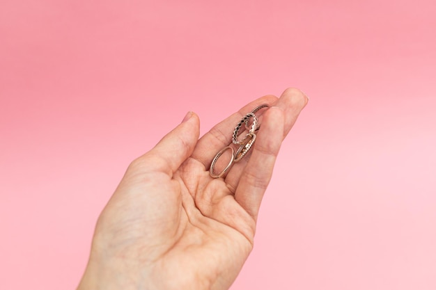 Silver jewelry on a pink background