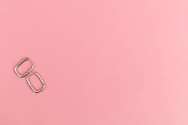 Silver jewelry on a pink background