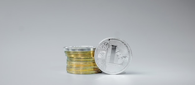 silver litecoin coin stack on grey background