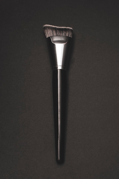 Silver makeup contour brush with black background