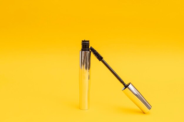 Silver mascara with yellow background