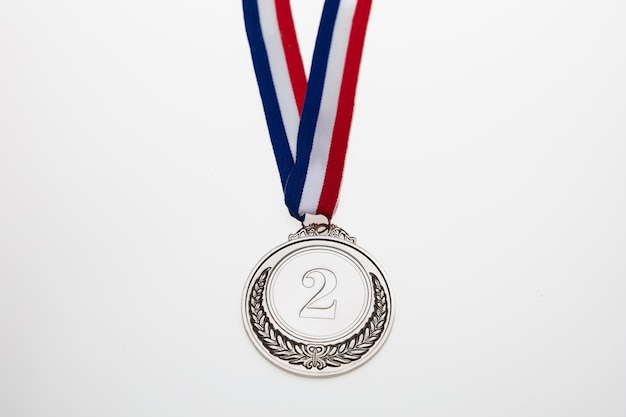 Silver medal Champion trophy award and ribbon Prize in sport for second place isolated on white