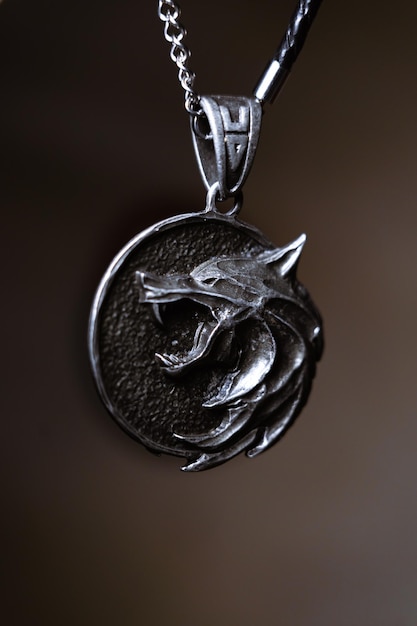 A silver medallion with a wolf on it