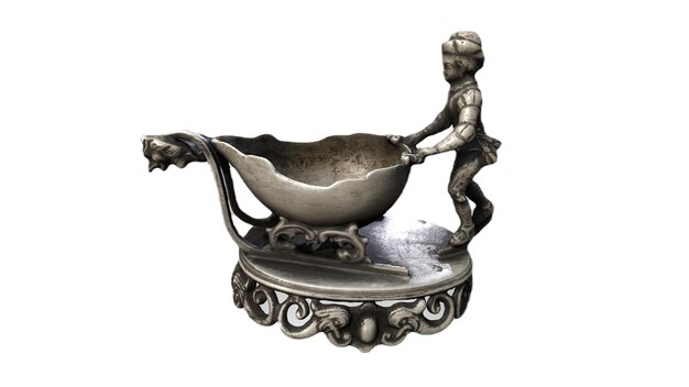 Photo a silver metal figure with a man pushing a sled.