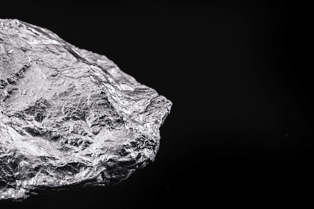 Silver nugget native to liberia isolated on black background