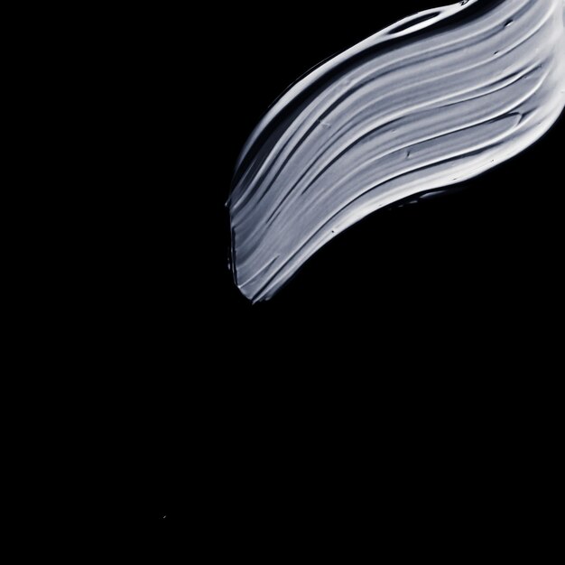 黒の背景グラマー化粧サンプル汚れに分離されたシルバー ペイント ブラシ ストローク テクスチャ