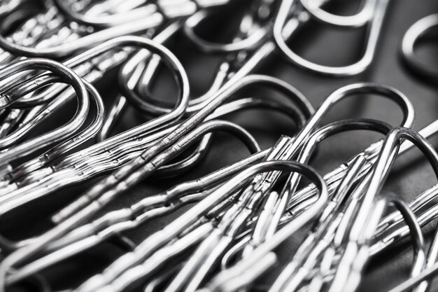 Silver paper clips textured background, full screen