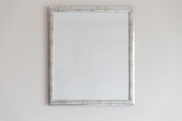 Silver picture frame on white wall