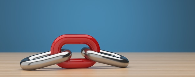 silver and red chain rings on wood