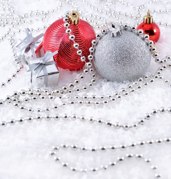 Silver and red Christmas decorations on a white background