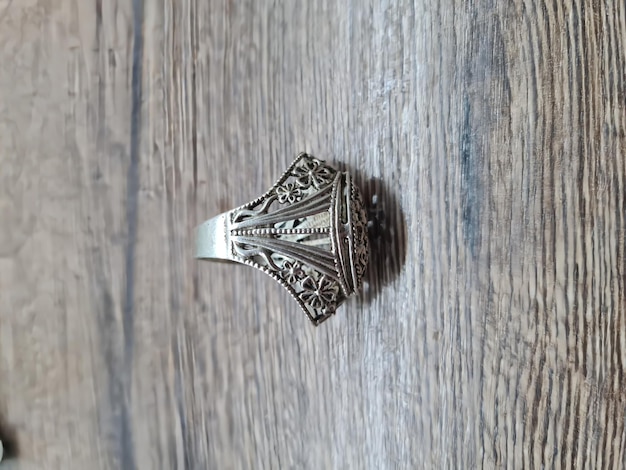 A silver ring with a floral design on it.