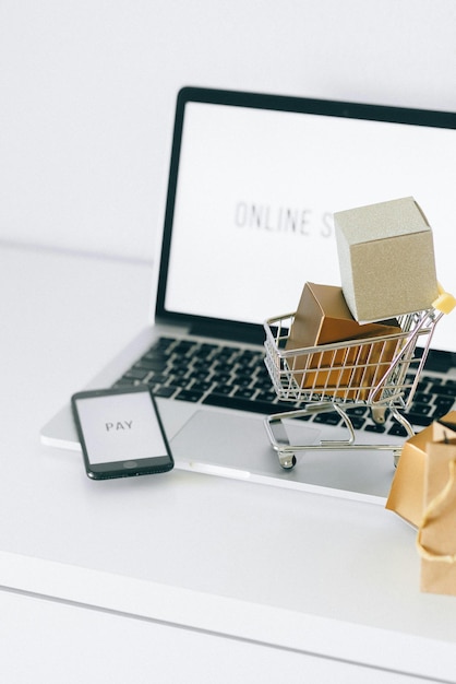 Photo silver shopping cart with brown paper bag stock photo