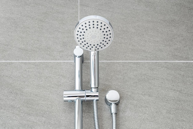 Silver shower head closeup in bathroom