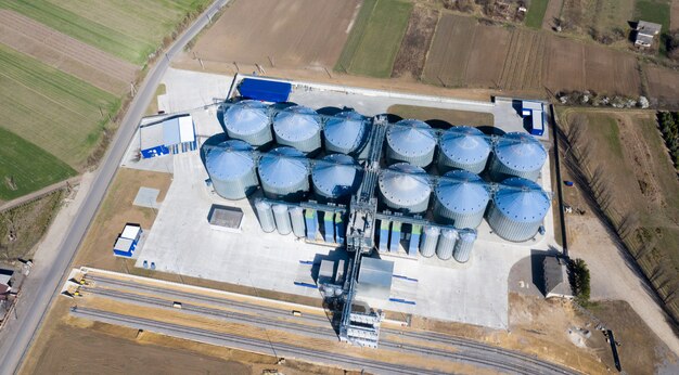 Silver silos on agro-processing and manufacturing plant for processing drying cleaning and storage of agricultural products