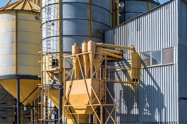 Silver silos on agroprocessing and manufacturing plant for processing drying cleaning and storage of agricultural products flour cereals and grain Granary elevator