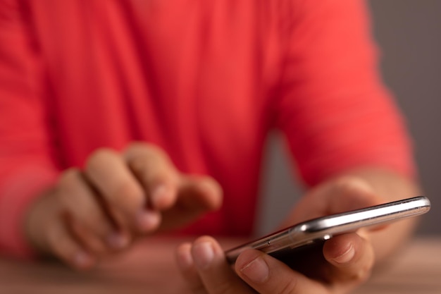 Silver smartphone in the hands of a man