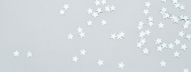 silver stars confetti on gray banner christmas or winter festive background