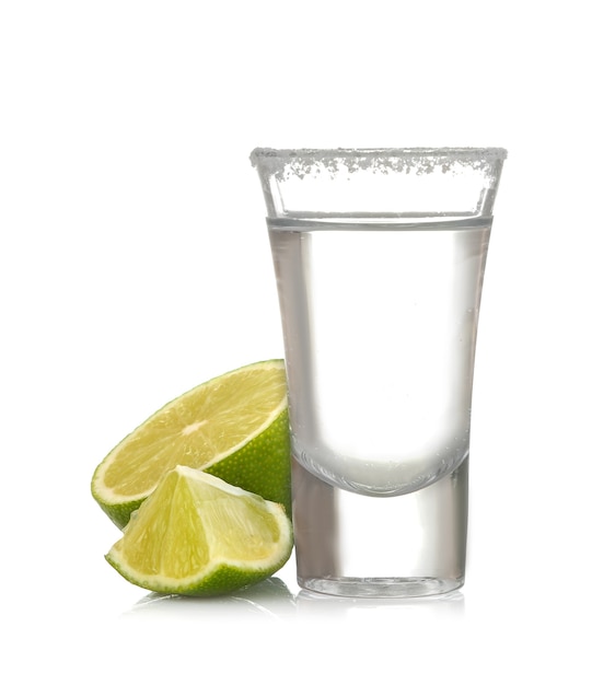 Silver tequila in a glass glass with lime close up on a white isolated background