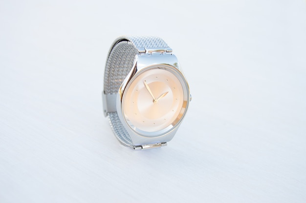 silvercolored watch on a white background