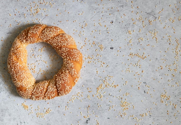 Simitturkish bagel with sesame on light concrete background\
with copyspace