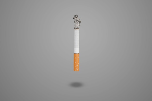 a simple abstract smoking burning cigarette isolated on color background with copy space