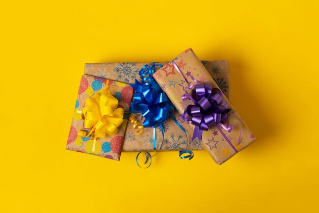 A simple abstract stack of present paper boxes with ribbon isolated on color background