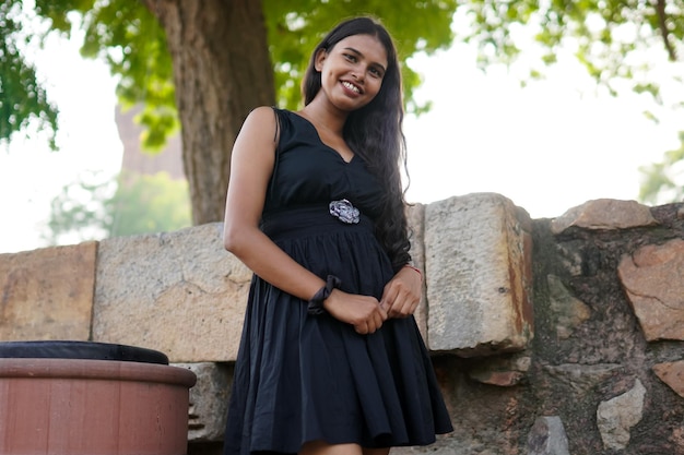 Simple asian woman standing along with wall outdoor shoot