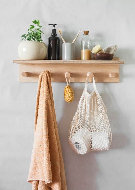 A simple bathroom interior a wooden shelf with a towel shampoo a flower Minimalism style