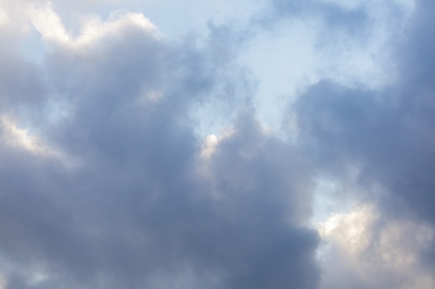 Simple beautiful gloomy blue sky with fluffy clouds on peaceful summer morning