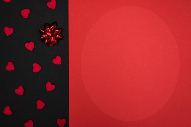 A simple black and red background for congratulations with a red bow and hearts, for Valentine's day