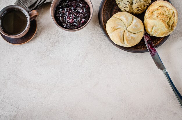 Simple breakfast: coffee americano, fresh buns and jam.