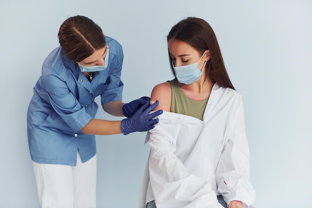 SImple but effective procedure Doctor in uniform making vaccination to the patient