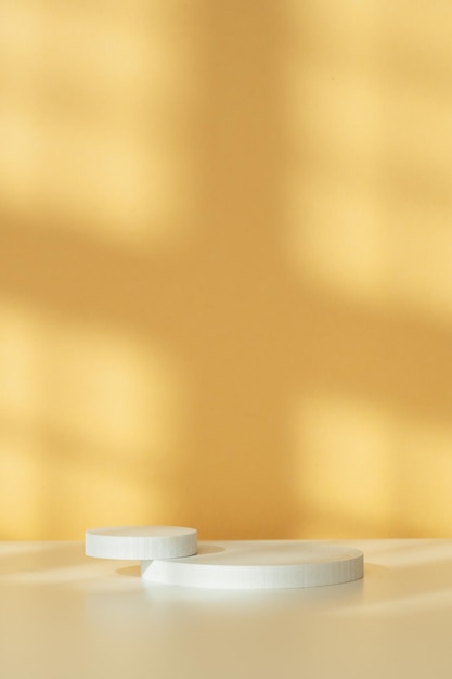 Simple minimalist white geometric shapes on a light orange background in natural lighting