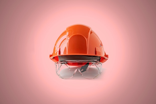 A the simple orange head helmet, abstract minimalistic concept of the safety job