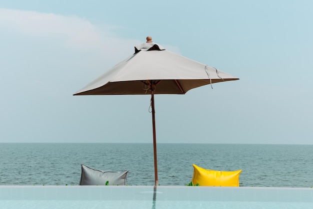 The simple photograph of beach umbrellas and seaside seat
