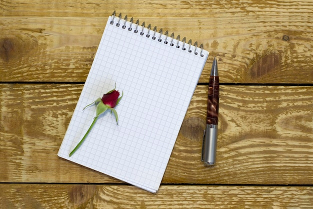 Simple small envelope with space for writing on wooden background with pen narrow focus line shallow depth of field