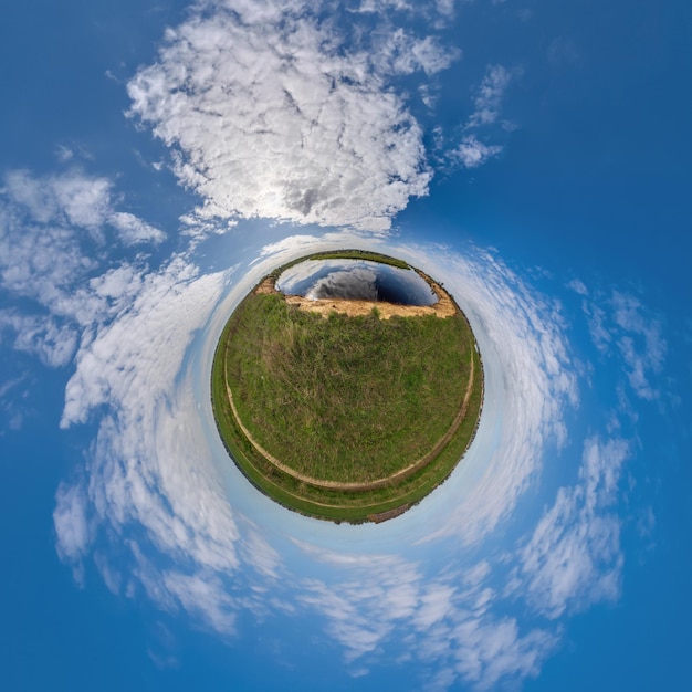 Simple tiny planet without buildings in blue sky with beautiful clouds Transformation of spherical panorama 360 degrees Spherical abstract aerial view Curvature of space