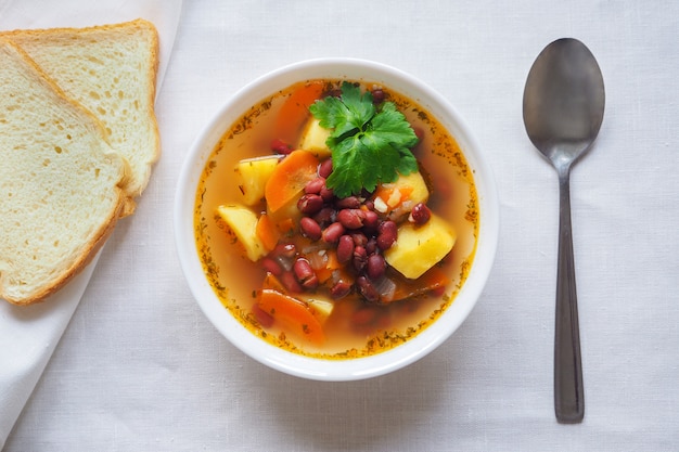 A simple vegetable soup with red beans. Top view.