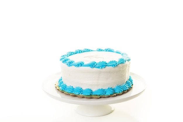 Simple white Birthday cake with white and blue icing.