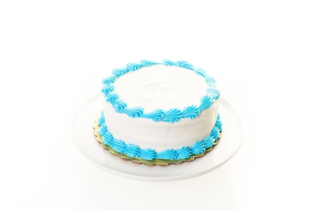 Simple white Birthday cake with white and blue icing.