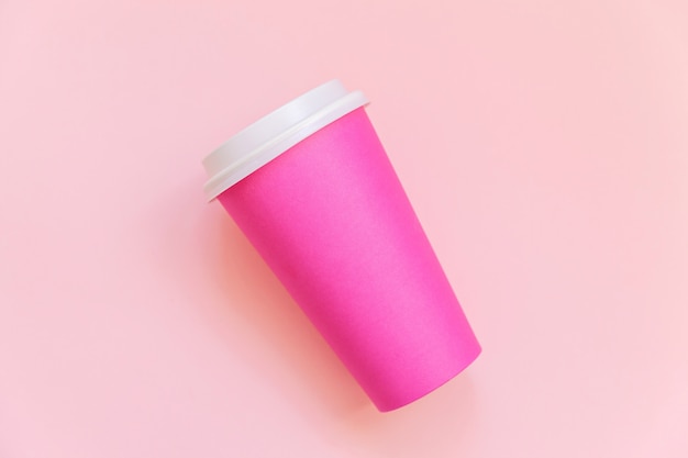 Simply flat lay design pink paper coffee cup on pink pastel colorful trendy background