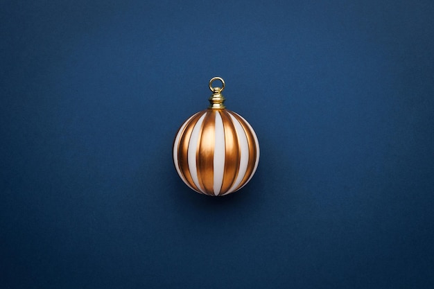 Simply minimal composition winter object ornament ball on color background flat lay