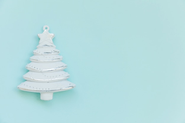 Simply minimal composition winter object ornament fir tree isolated on blue background