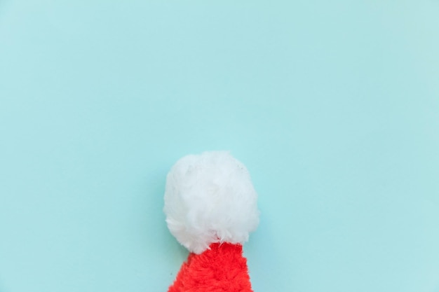 Simply minimal design Christmas Santa Claus hat isolated on blue pastel colorful trendy background. Christmas New Year december time for celebration concept. Flat lay top view copy space