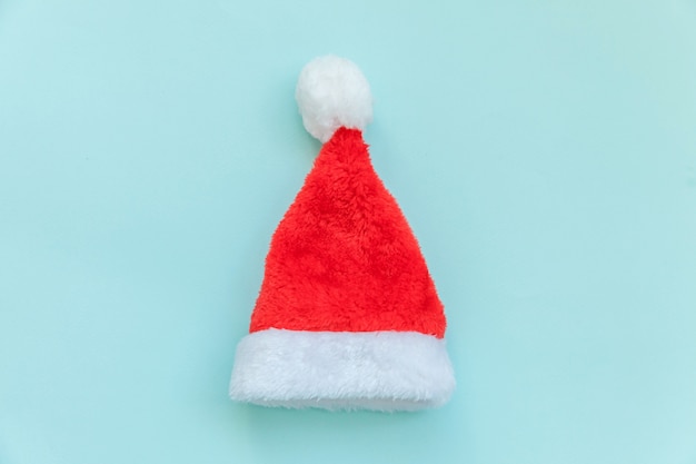 Simply minimal design Christmas Santa Claus hat isolated on blue pastel colorful 